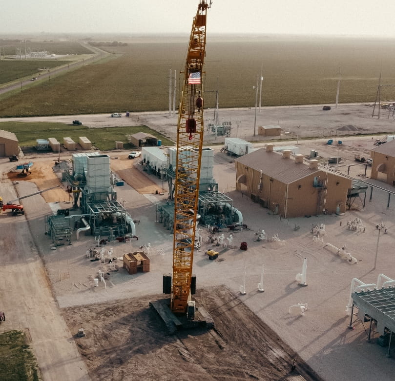 Crane flying an American flag at a Ranger Plant construction site